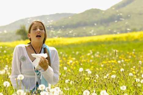 allergy season sneezing woman flower field