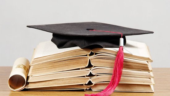 Graduation cap stack of books diploma