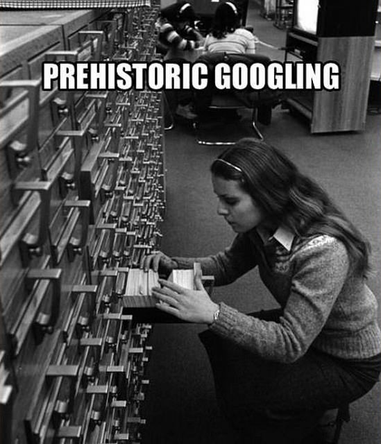 Woman searching card catalog history historical google
